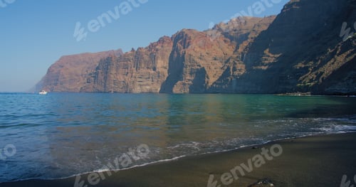 Preview: Los Gigantes cliffs and overlooking the ocean from black sandy volcanic beach.