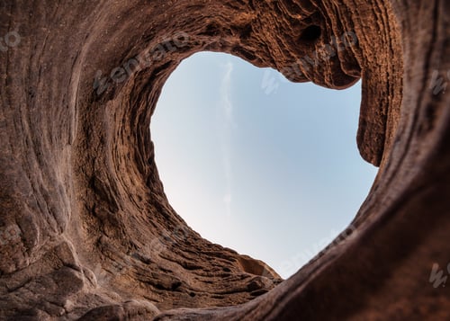 Preview: Natural stone hole cave of eroded surface by water with blue sky in national park