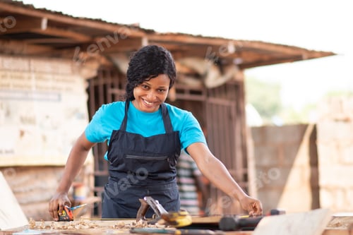 Preview: Closeup shot of a beautiful African carpenter female in her workshop