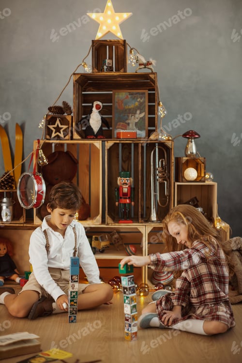 Preview: Two Kids Playing With Toys Near the Christmas Tree