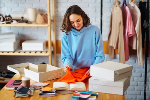 Preview: Close-up of preparing a parcel on the table. Woman online store, small business owner, entrepreneur.