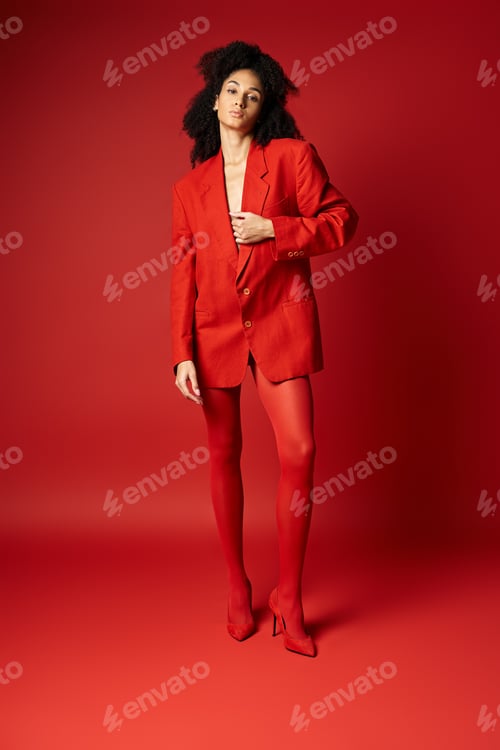 Preview: Scarlet elegance: woman in red suit posing