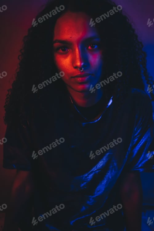 Preview: Artistic portrait with color lights of a young woman