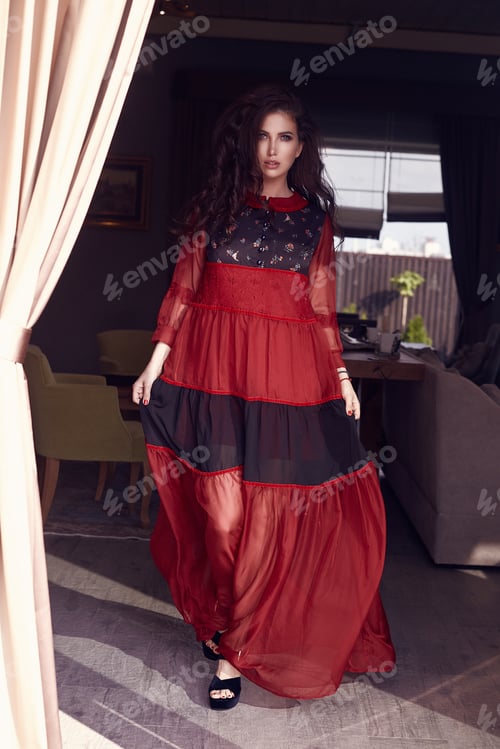 Preview: Portrait Of Gorgeous Sensual Brunette Model In Fashion Red Dress Posing In Interior