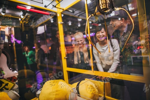 Preview: Woman playing toy grabbing game with friends