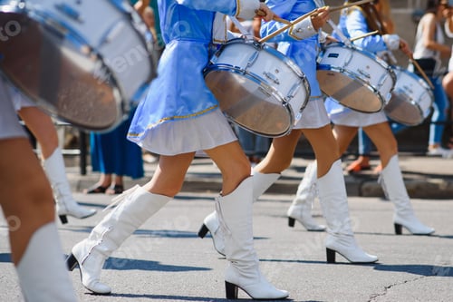 Preview: majorettes with white and blue uniforms perform in the streets of the city. photographic series