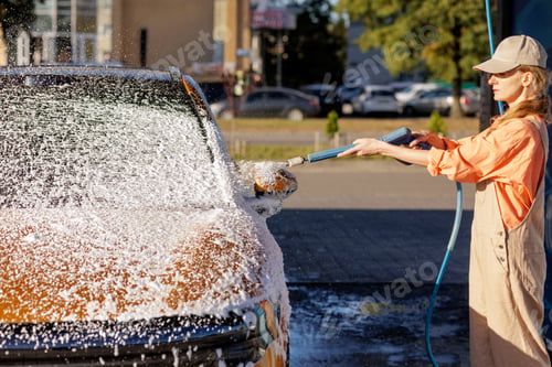 Preview: High pressure car wash with foam and spray on vehicle outdoors