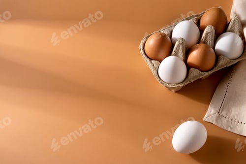Preview: Brown and white chicken egges on beige background. Chicken eggs on the table.