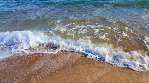 Preview: Sea water with white foam on the coastal sand