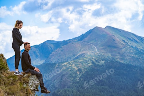 Preview: The happy man and a woman enjoying on the beautiful cliff