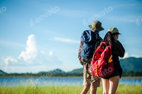 Preview: Hikers with backpacks walking trough forest path wearing mountain boots with focus on the shoes.