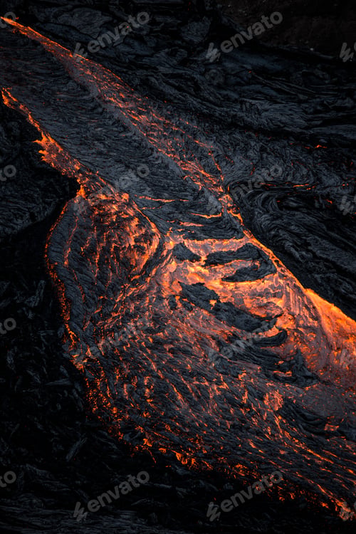 Preview: Mesmerizing vertical shot of lava flowing over the bumpy mountain