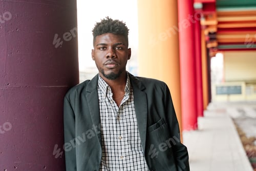 Preview: Man in Blazer Posing By Colorful Columns