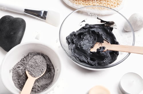 Preview: Preparing cosmetic black mud mask in glass bowl