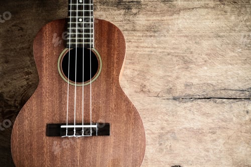 Preview: Close up of ukulele on old wooden background