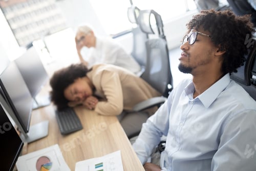Preview: Overworking concept. Group of business people exhausted in office