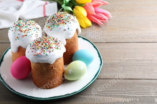 Preview: Beautiful Easter cakes and painted eggs on wooden table. Space for text