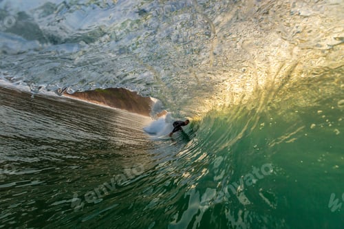 Preview: Male surfer doing tricks taking over the strong waves of the ocean in Algarve, Portugal