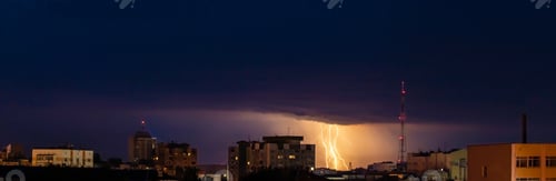 Preview: Lightning over city. Panoramic dramatic view. Thunderstorm and dark storm clouds over buildings.