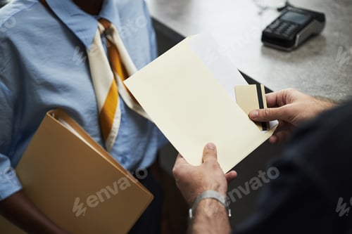 Preview: Hands of Man Taking Credit Card out of Envelope in Bank Office