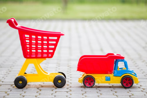 Preview: Bright plastic colorful toys for children outdoors on sunny summer day