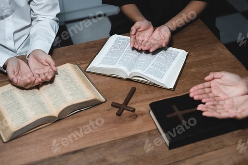 Preview: Asian men and women hands praying to god with the bible.