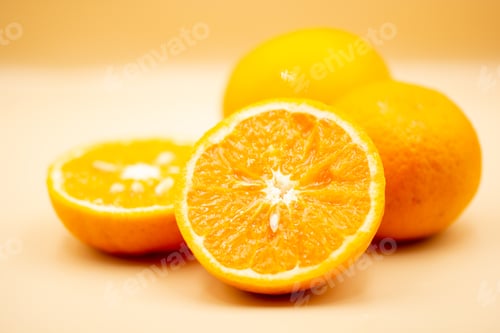 Preview: Oranges on pink background. One orange is cut in half, the other is whole.