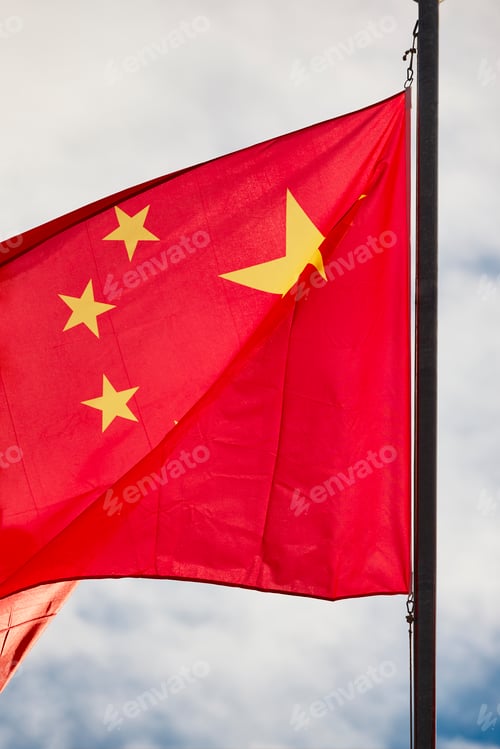 Preview: China flag waving over a blue sky. Chinese national emblem