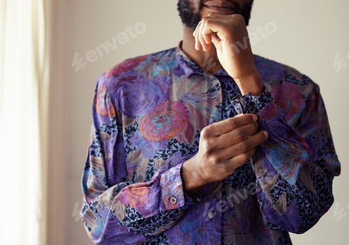 Preview: Dont I look dapper. Shot of an unrecognizable man buttoning a shirt at home.