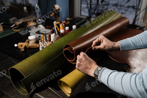Preview: Leather worker touching genuine leather roll during inspection