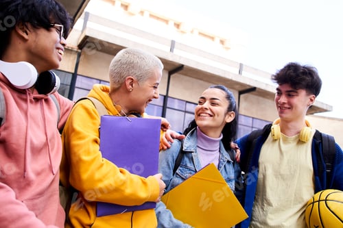 Preview: Group of happy students outside the school hugging each other having fun.