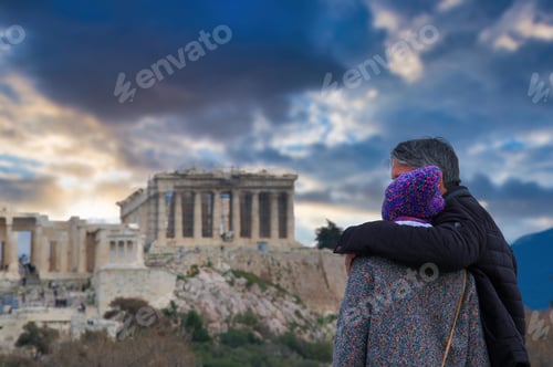 Preview: couple in love looks embracing the Acropolis of Athens, Greece