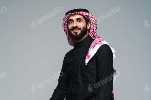 Preview: Handsome saudi arabian middle-eastern man with traditional thwab portrait in studio