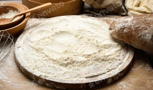 Preview: White wheat flour and wooden rolling pin on board, baking ingredients