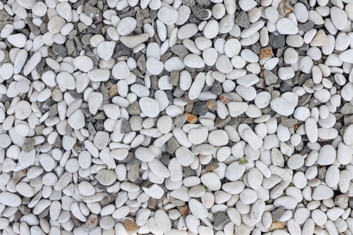 Preview: Top View Of Textured Surface Covered In Mix Of Smooth White And Rough Grey Pebbles