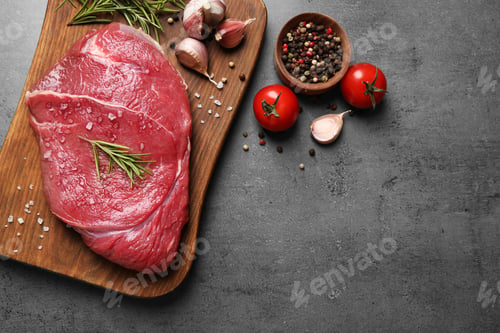 Preview: Flat lay composition with fresh meat on grey table. Space for text