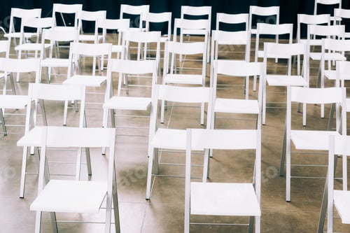 Preview: close up view of arranged empty white chairs in conference hall