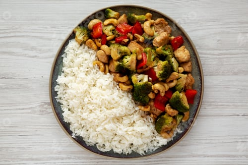 Preview: Homemade Cashew Chicken Stir-Fry on a Plate, top view. Flat lay, overhead, from above.