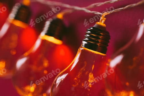 Preview: Beautiful illuminated festive light bulbs garland close up