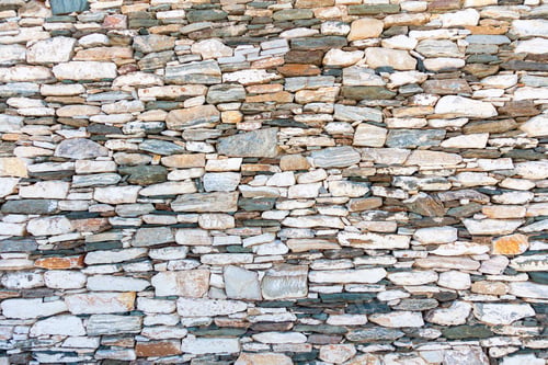 Preview: Vintage stone wall background and texture, Cyclades islands Greece.