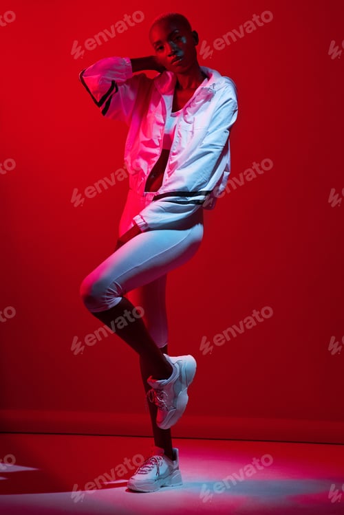 Preview: Dressed for a sweat session. Red filtered shot of a sporty young posing in the studio.