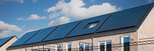 Preview: Newly build houses with solar panels attached on the roof against a sunny sky