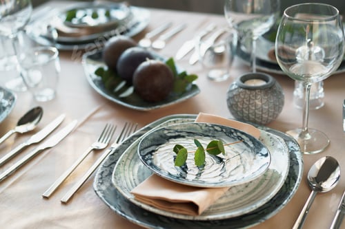 Preview: Beautiful elegant table setting with green stylish dishware and silver cutlery