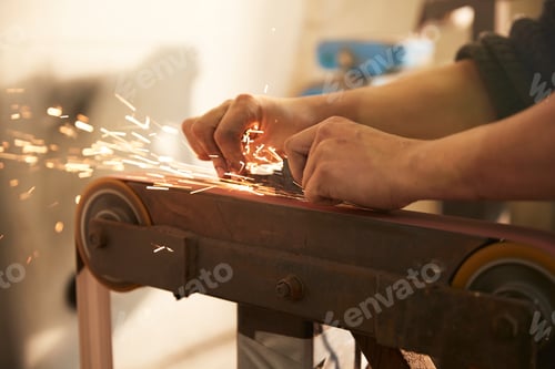 Preview: Man grinding a blade in a workshop
