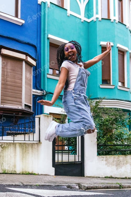 Preview: Exuberant Young Lady Jumping for Joy in the City