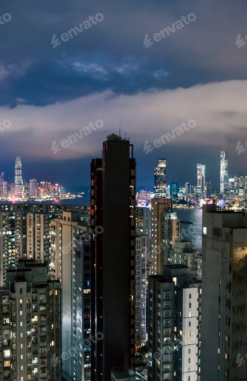 Preview: Vibrant night skyline of high-rise buildings in Hong Kong with illuminated cityscape
