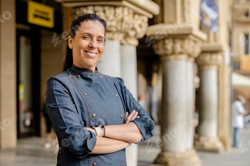 Preview: Woman chef posing outdoors on the street