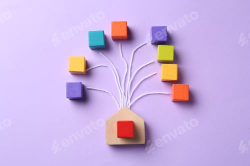 Preview: Family tree made with colorful cubes and house figure on lilac background, top view