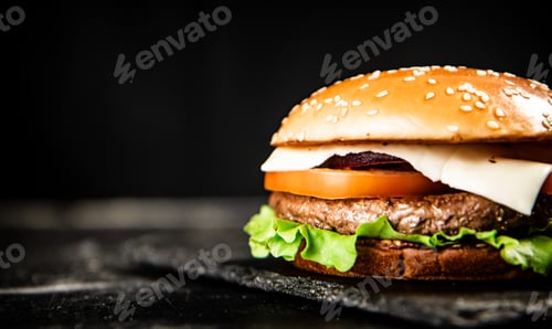 Preview: A burger on a stone board on a table.