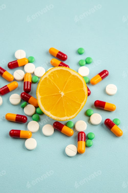 Preview: front view different pills with orange slice on light blue background pandemic virus science covid